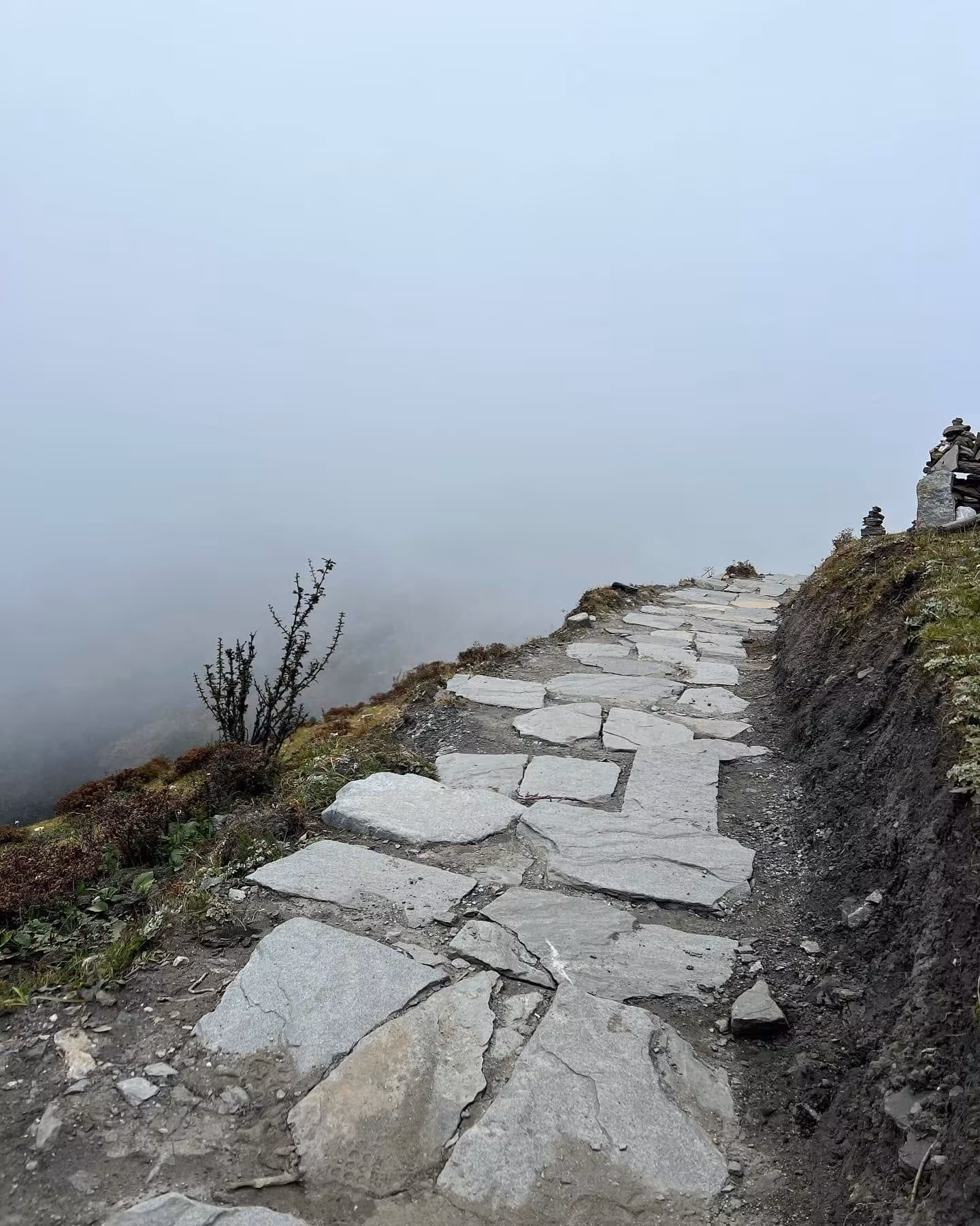 Flagstone path along the ridge at Chele La in cloud