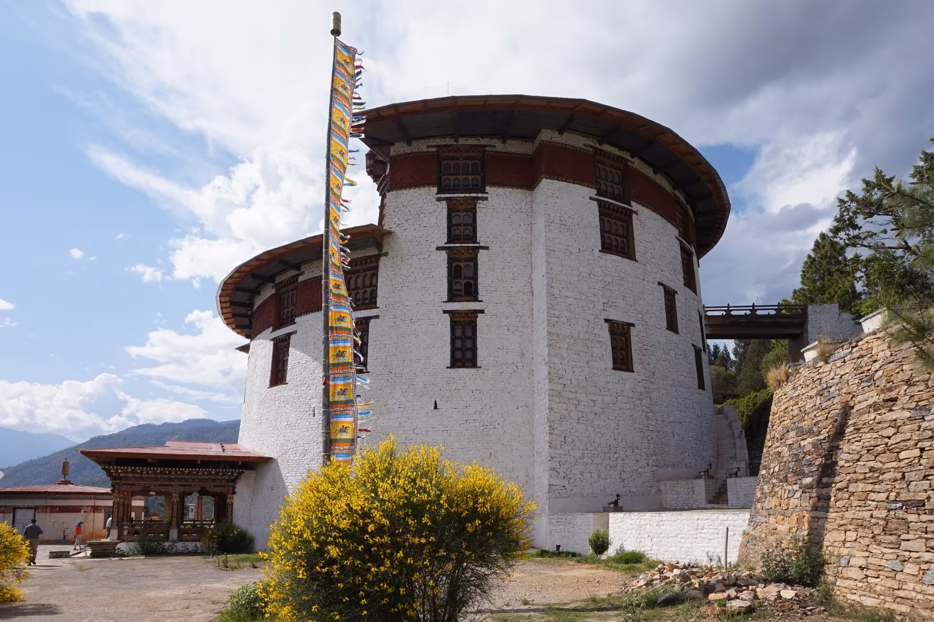 A prayer-flag pole beside the National Museum of Bhutan