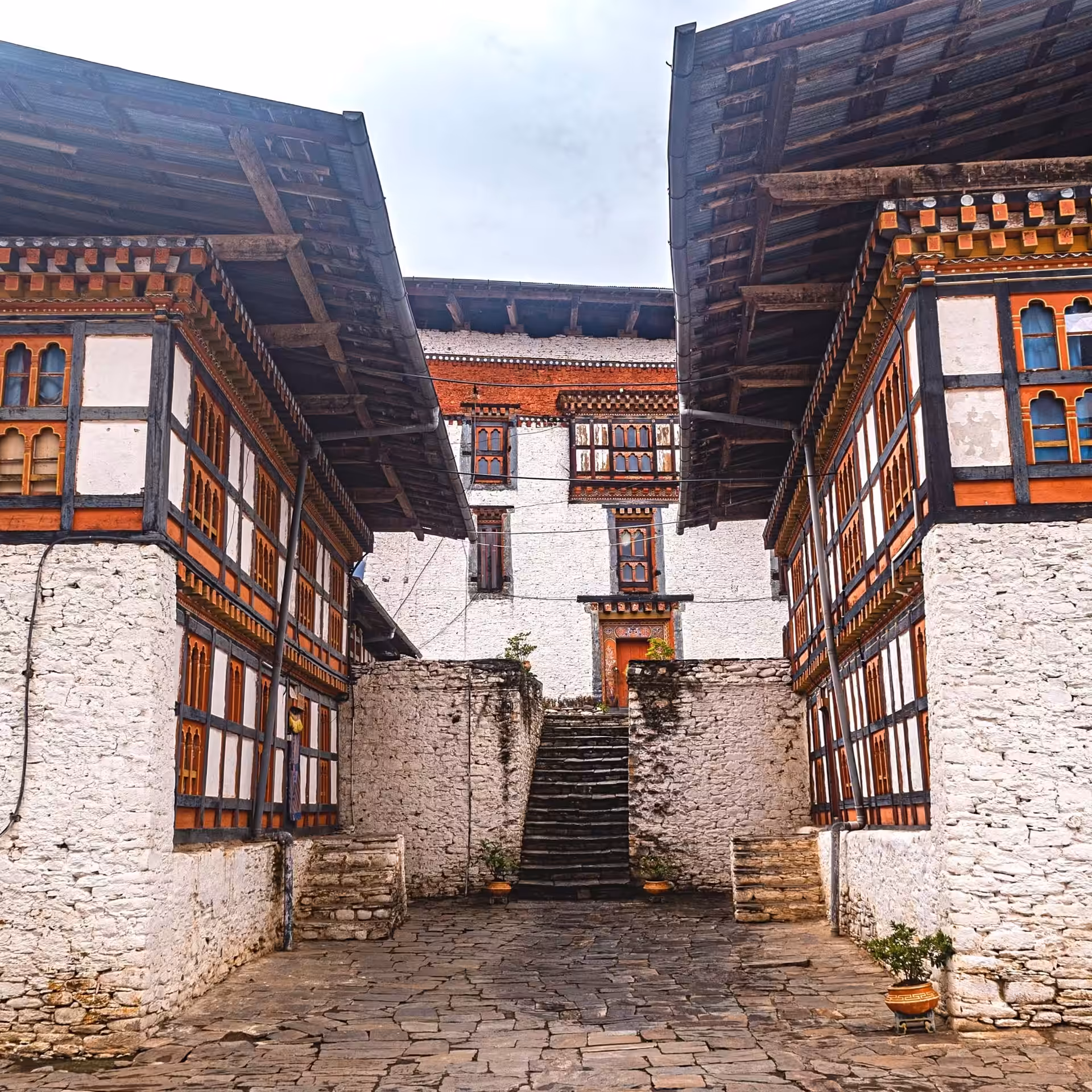 Flagstone courtyard between the whitewashed wings of Jakar Dzong