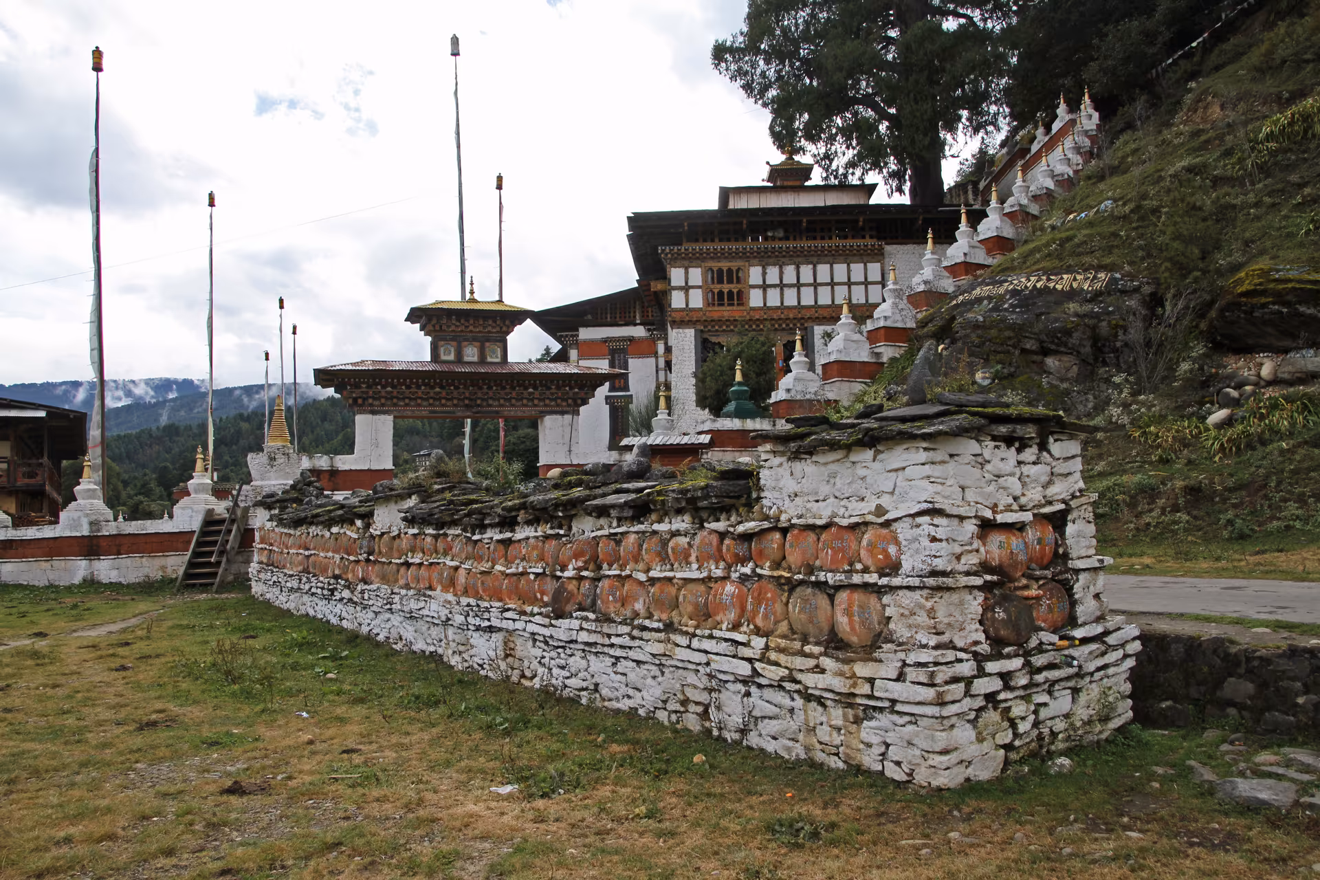 Stone mani wall and chortens in the Kurjey Lhakhang grounds
