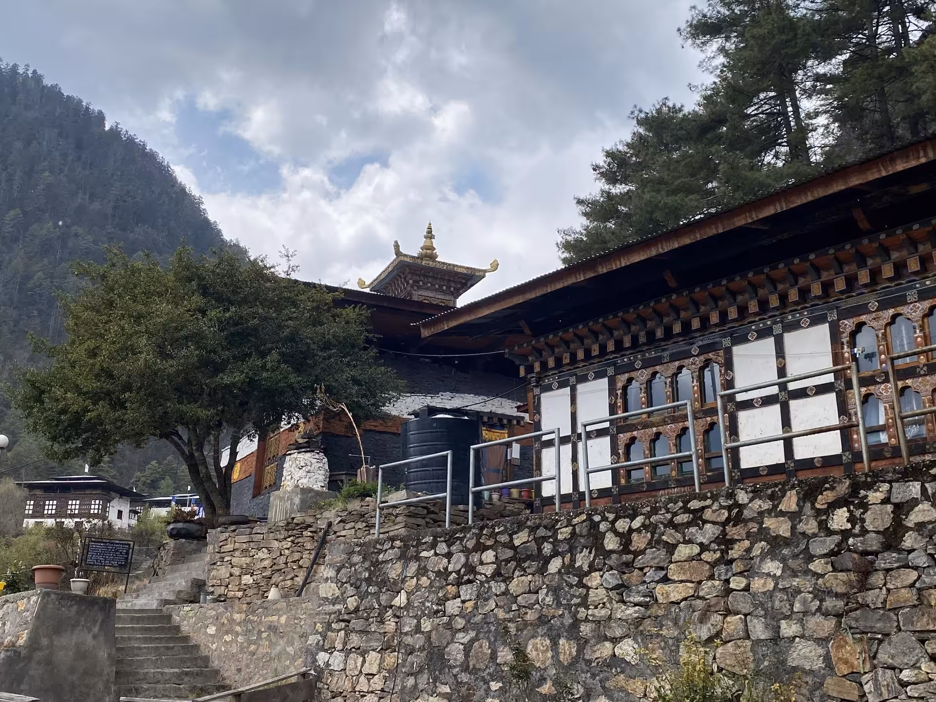 Lhakhang Nagpo above its stone retaining wall